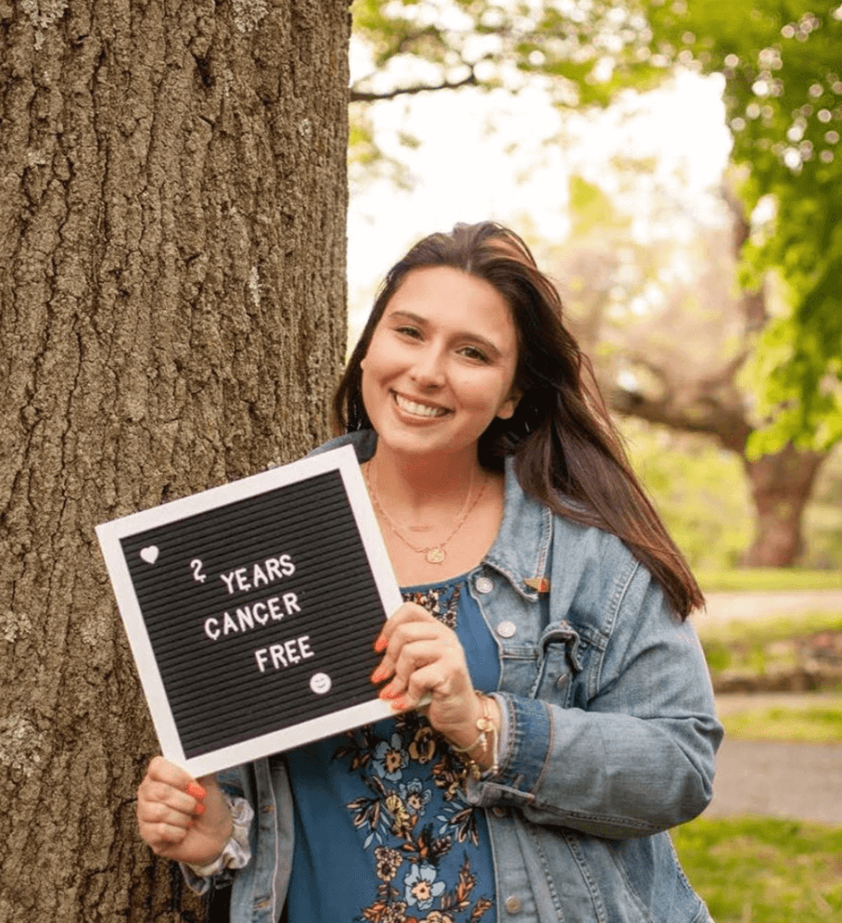 woman holding cancer free sign