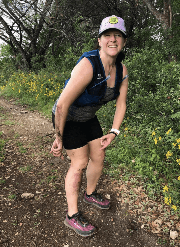 woman hiking with scraped leg and arm