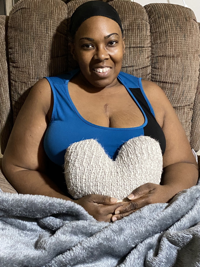 LaSonya D. seated with heart-shaped pillow