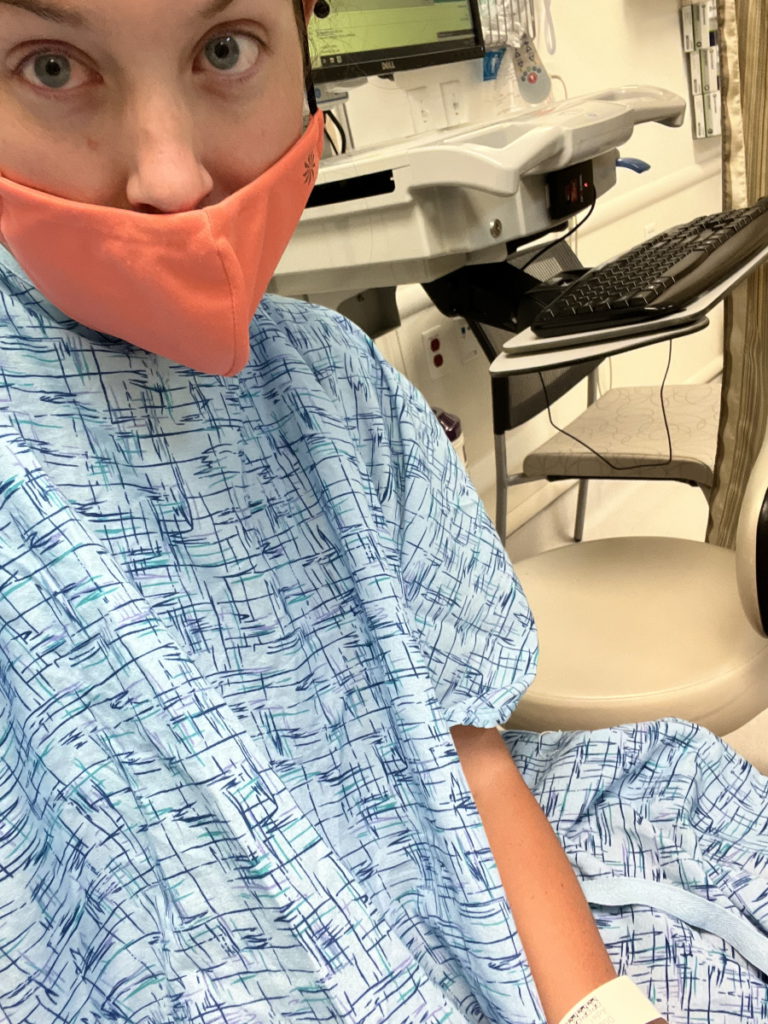 Paige C. in hospital gown with orange mask