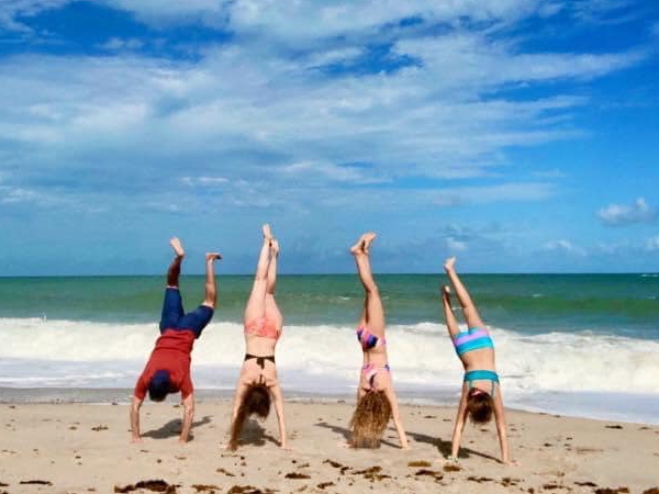 Bethany W. handstands at the beach