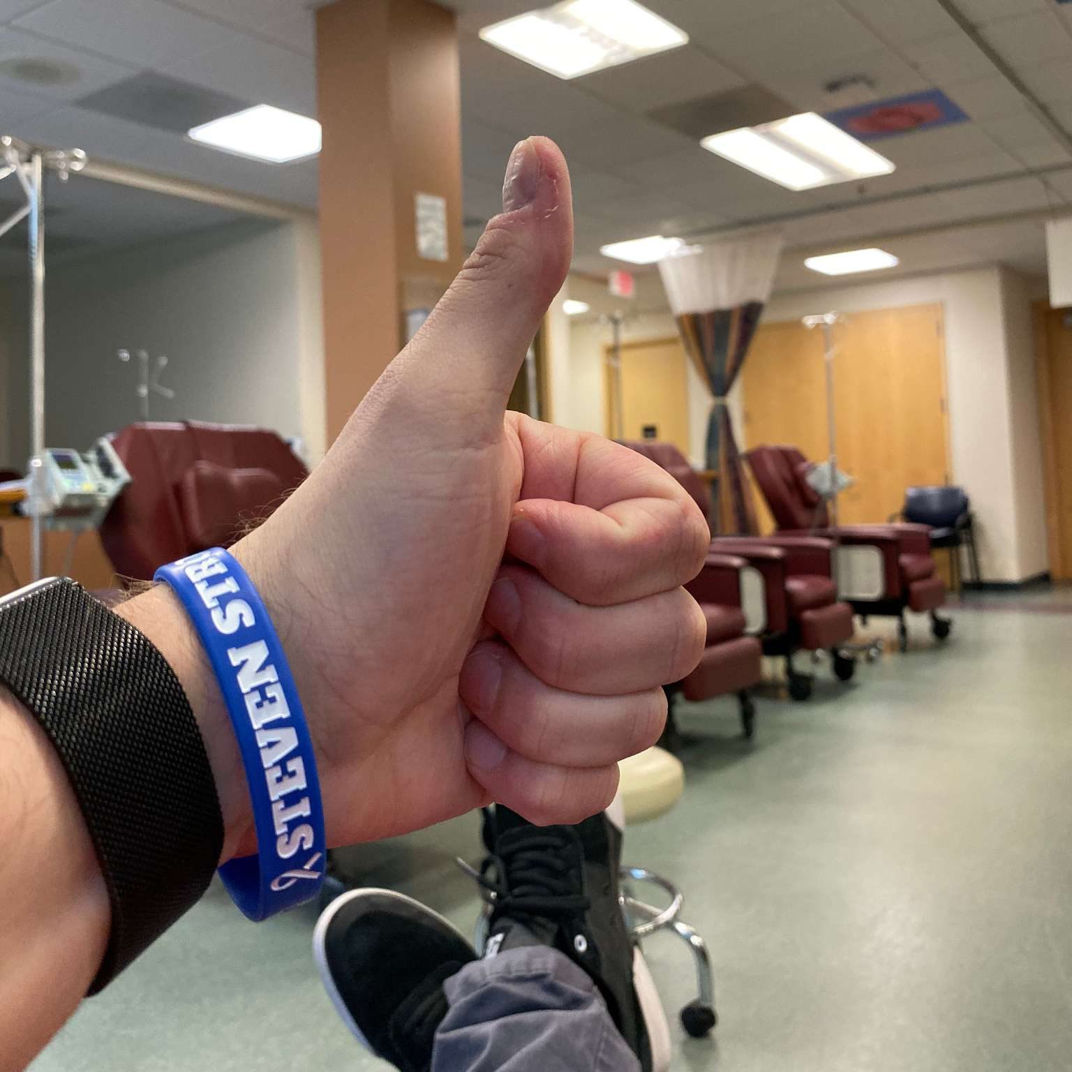 Steven giving a thumb's up on his last day of chemotherapy 