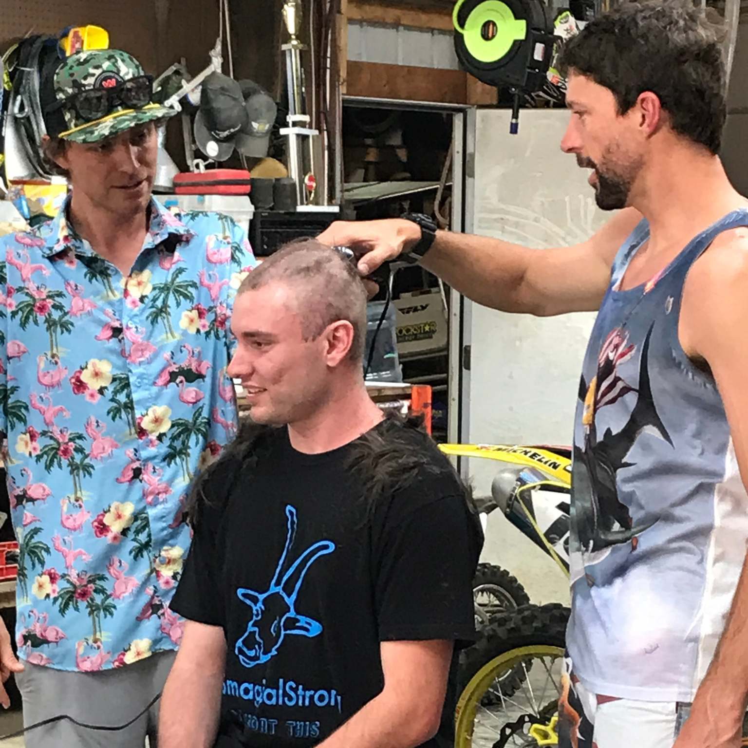 Smagical and Travis Pastrana shaving Steven C.'s head before chemo