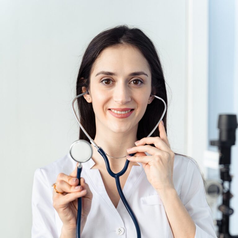 Doctor smiling while holding a stethoscope