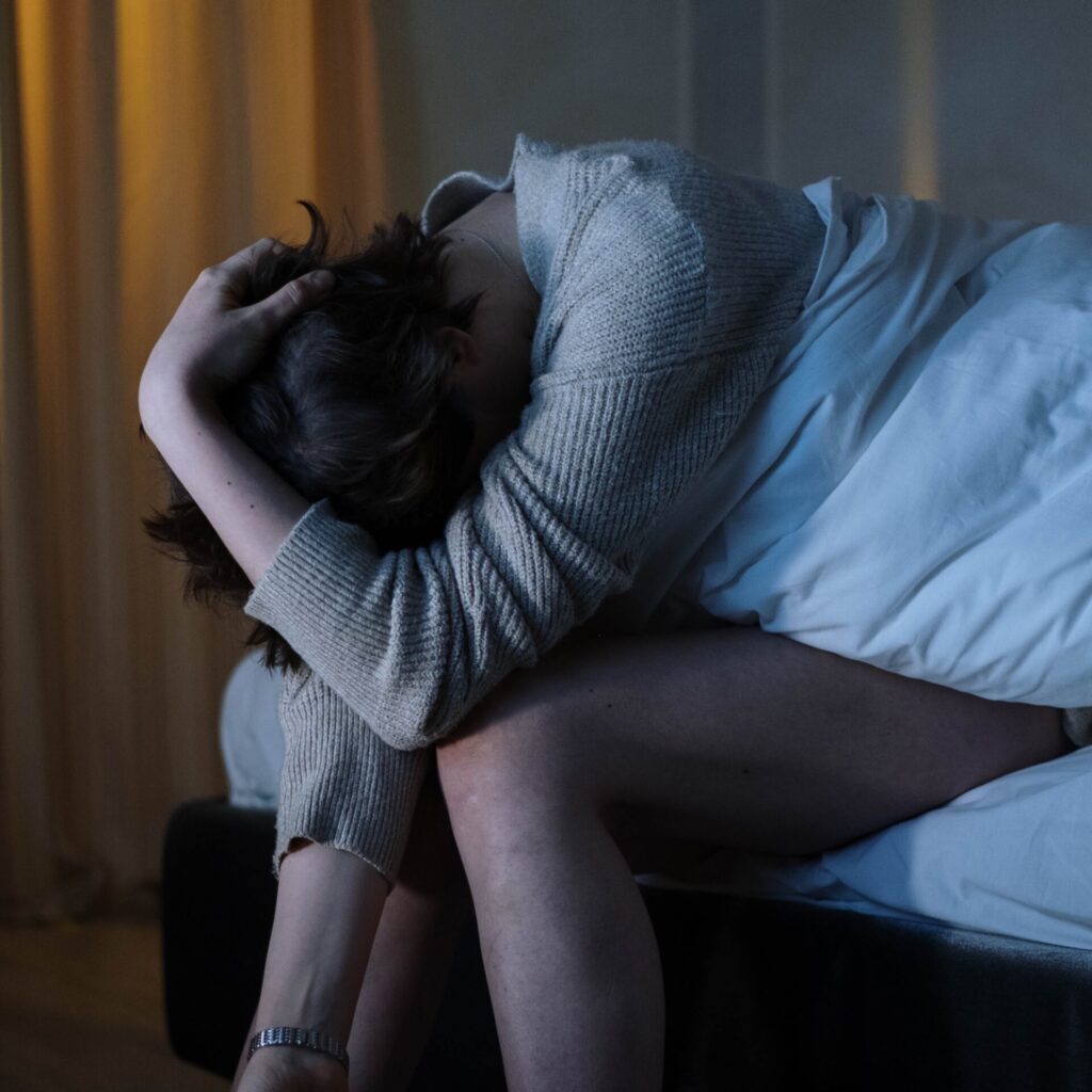 Exhausted woman experiencing CLL symptoms.