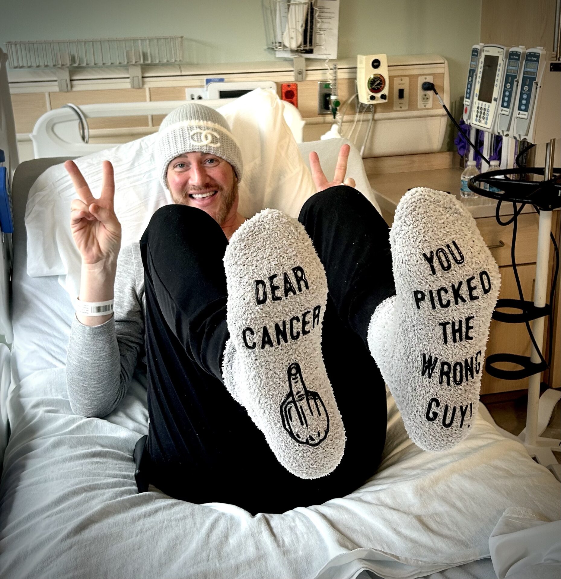 Kyle with his socks that say "Dear Cancer, you picked the wrong guy!"